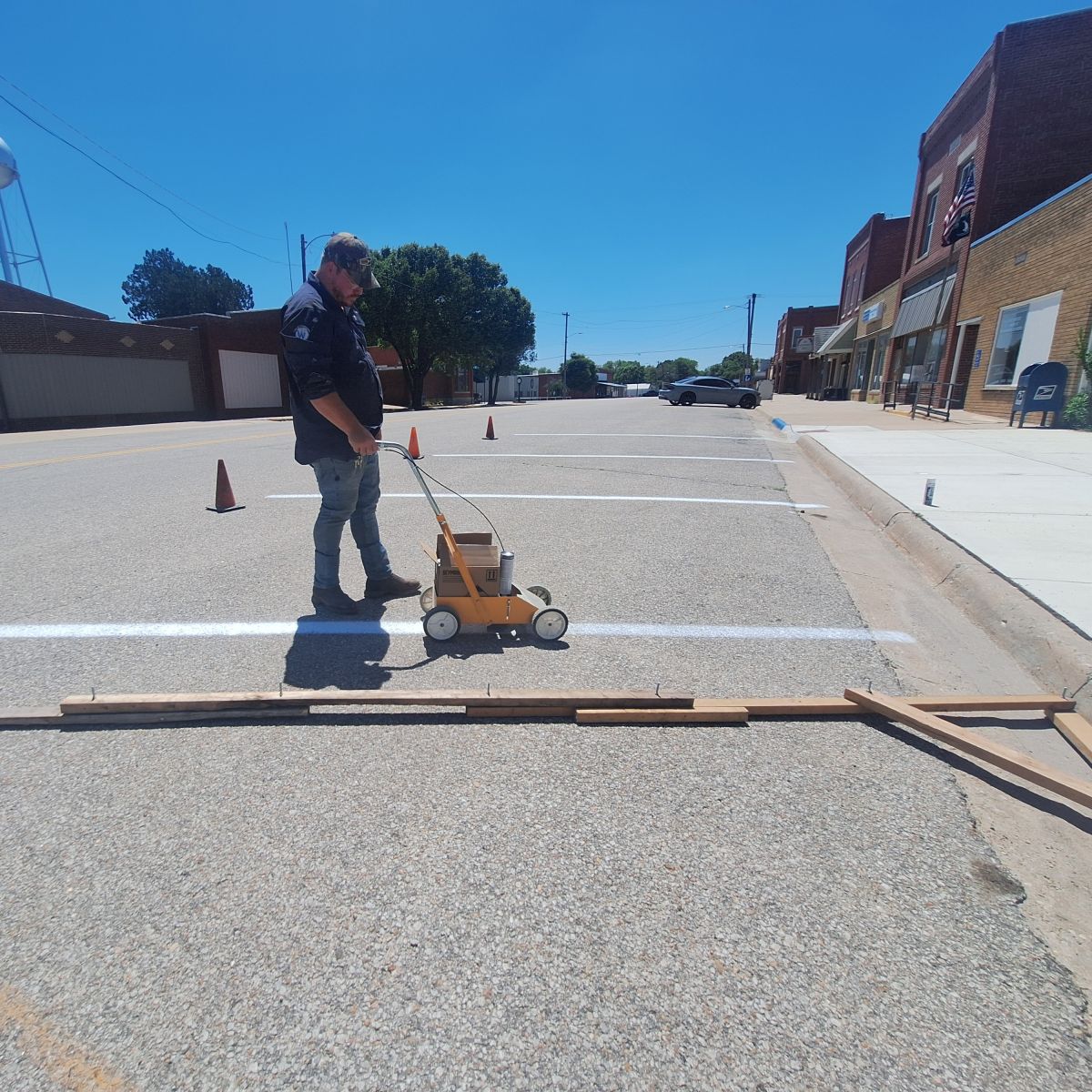 city worker painting parking lines