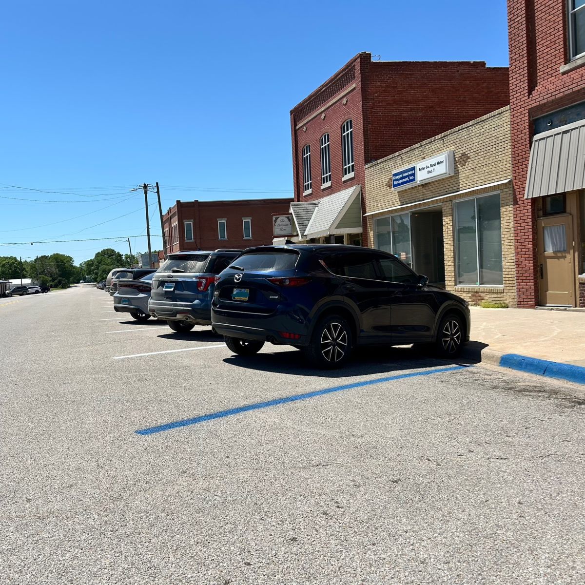 Cars parked inside painted parking spaces in the Business District