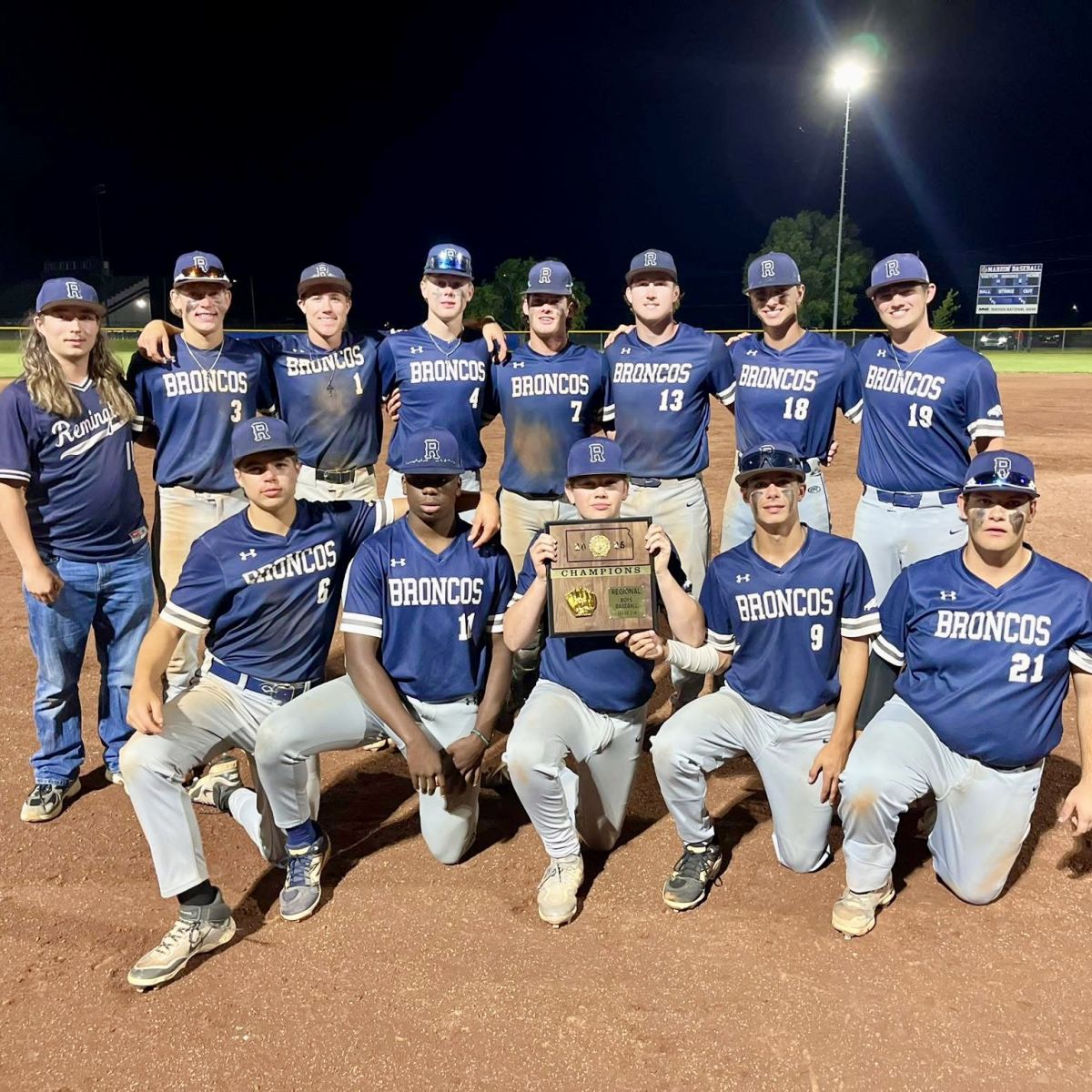 Boys baseball team holding Regional Champs plaque, Going to State!