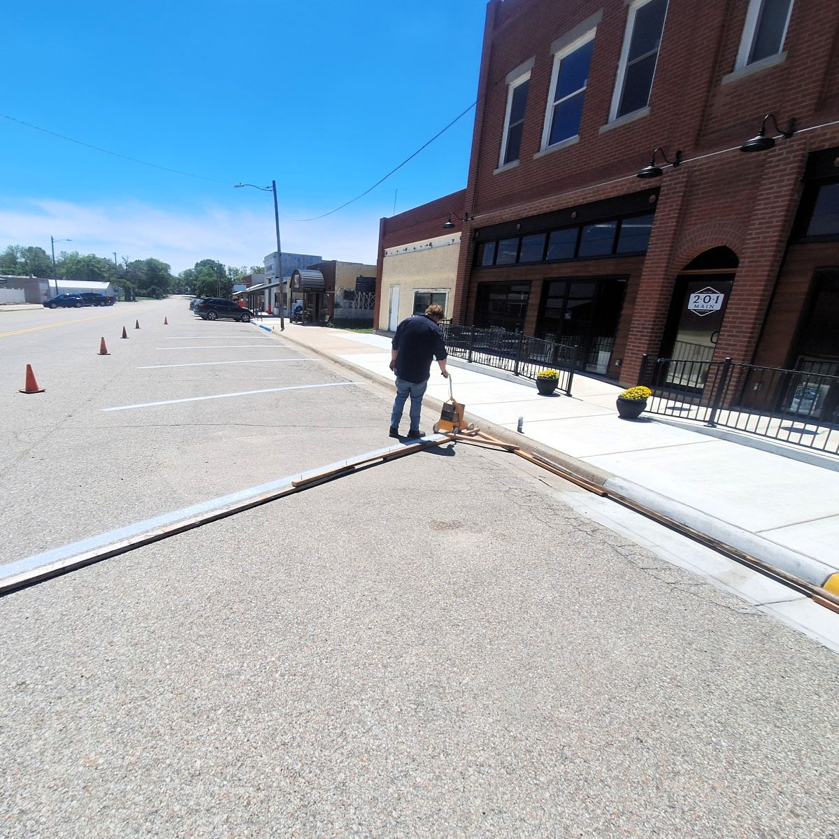 city worker painting parking lines