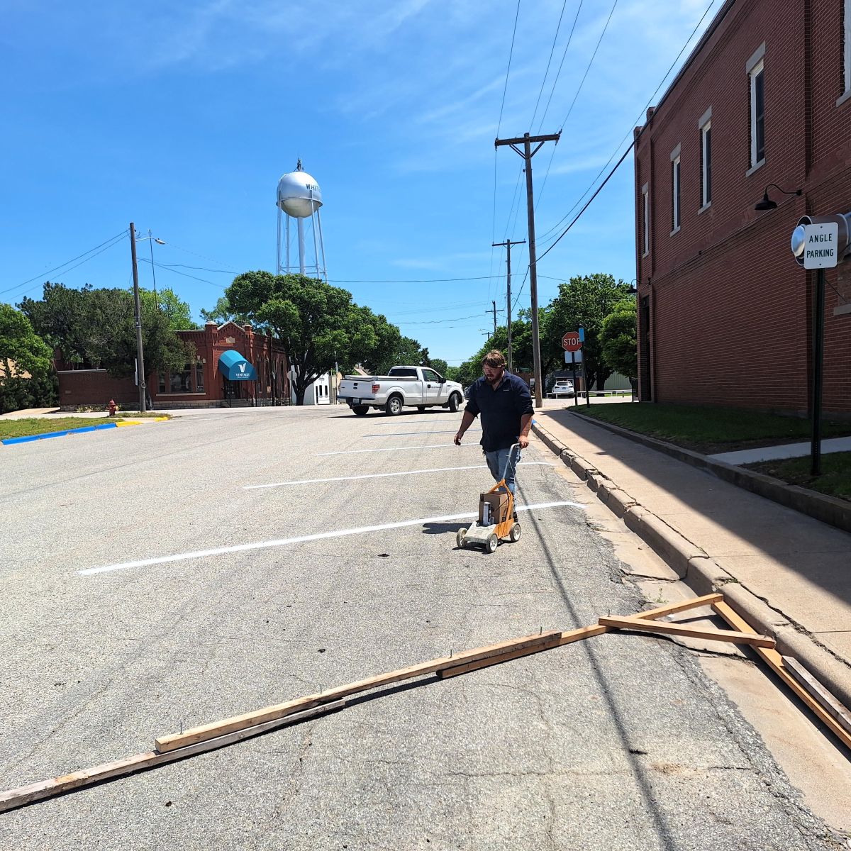 city worker painting parking lines